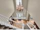 Elegant foyer with a chandelier, decorative front door, hardwood floors, and staircase with neutral colors at 7325 Brookwood Way, Cumming, GA 30041