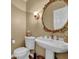 Charming half bathroom features a pedestal sink, ornate mirror, and classic fixtures at 7325 Brookwood Way, Cumming, GA 30041