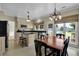 Bright kitchen with black countertops, stainless steel appliances, and an adjacent breakfast nook with seating at 7325 Brookwood Way, Cumming, GA 30041