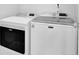 Laundry room with a white Maytag washer and dryer at 7325 Brookwood Way, Cumming, GA 30041