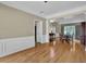 Spacious living room with hardwood floors, and views of dining room and staircase at 7325 Brookwood Way, Cumming, GA 30041