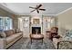 Cozy living room with a fireplace, built-in cabinets, and comfortable seating, perfect for relaxation at 7325 Brookwood Way, Cumming, GA 30041