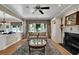 Comfortable living area featuring a fireplace, hardwood flooring, and backyard views at 7325 Brookwood Way, Cumming, GA 30041