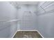 Clean and simple walk-in closet with shelving for organization and storage at 7325 Brookwood Way, Cumming, GA 30041