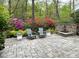 Private backyard with stone patio, colorful azaleas, and outdoor seating at 366 Blackland Nw Rd, Atlanta, GA 30342