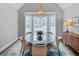Elegant dining room with a circular glass table, bay window, and stylish light fixture at 366 Blackland Nw Rd, Atlanta, GA 30342