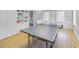 Recreation room with a ping pong table, built-in shelving, and laminate floors at 366 Blackland Nw Rd, Atlanta, GA 30342