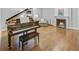 Living room with a piano, fireplace, comfortable seating, and hardwood floors at 366 Blackland Nw Rd, Atlanta, GA 30342