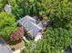 Aerial view of the beautiful home surrounded by lush trees and greenery, providing privacy at 605 Linkside Hollow, Alpharetta, GA 30005