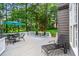 Spacious back deck ideal for outdoor dining, featuring a view of mature trees at 605 Linkside Hollow, Alpharetta, GA 30005