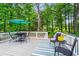 Spacious back deck ideal for outdoor dining, featuring a view of mature trees at 605 Linkside Hollow, Alpharetta, GA 30005