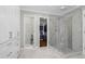 Bright bathroom featuring a walk-in glass shower, and access to a walk-in closet at 605 Linkside Hollow, Alpharetta, GA 30005