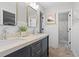Bathroom with double sink vanity, framed mirrors, and a walk-in shower at 605 Linkside Hollow, Alpharetta, GA 30005