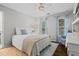 Cozy bedroom featuring hardwood floors, a ceiling fan, and lots of natural light at 605 Linkside Hollow, Alpharetta, GA 30005