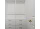 Custom closet with drawers and rods, providing ample storage space at 605 Linkside Hollow, Alpharetta, GA 30005