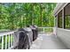 Deck featuring two grills and view of woodsy backyard at 605 Linkside Hollow, Alpharetta, GA 30005