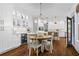 Inviting dining area with hardwood floors, white cabinets, and easy access to the kitchen at 605 Linkside Hollow, Alpharetta, GA 30005