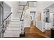 Grand foyer entrance with staircase, hardwood floors, and open floor plan at 605 Linkside Hollow, Alpharetta, GA 30005