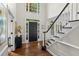 Elegant foyer features hardwood floors, a staircase, and natural light streaming through large windows at 605 Linkside Hollow, Alpharetta, GA 30005