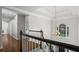 Bright hallway featuring a large window, hardwood floors, and decorative lighting at 605 Linkside Hollow, Alpharetta, GA 30005
