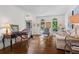 Cozy living room with hardwood floors, stylish furniture, and ample natural light at 605 Linkside Hollow, Alpharetta, GA 30005