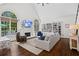 Inviting living room boasts vaulted ceilings, a fireplace, custom bookshelves, and hardwood floors at 605 Linkside Hollow, Alpharetta, GA 30005