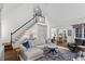 Spacious living room featuring a staircase, hardwood floors, fireplace, and a bright, airy feel at 605 Linkside Hollow, Alpharetta, GA 30005