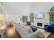 Bright living room with hardwood floors, fireplace, and views into the open concept kitchen at 605 Linkside Hollow, Alpharetta, GA 30005