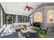 Comfortable screened-in porch with stylish seating, a ceiling fan, and views of the backyard at 605 Linkside Hollow, Alpharetta, GA 30005