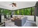 Relaxing sunroom featuring lots of natural light and views of the surrounding greenery at 605 Linkside Hollow, Alpharetta, GA 30005