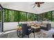 Relaxing sunroom featuring lots of natural light and views of the surrounding greenery at 605 Linkside Hollow, Alpharetta, GA 30005