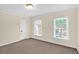 Light bedroom featuring two windows with view and plush carpet at 84 Mount Vernon Cir, Atlanta, GA 30338