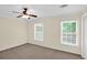 Bedroom with carpet floors, two windows, a ceiling fan, and a closet with double doors at 84 Mount Vernon Cir, Atlanta, GA 30338