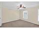 Carpeted bedroom with ceiling fan and one large window at 84 Mount Vernon Cir, Atlanta, GA 30338