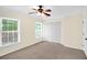 Bedroom with carpet floors, two windows, a ceiling fan, and a closet with double doors at 84 Mount Vernon Cir, Atlanta, GA 30338