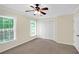Bedroom with carpet floors, two windows, a ceiling fan, and a closet with double doors at 84 Mount Vernon Cir, Atlanta, GA 30338