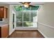 Bright dining area with wood floors, large windows, and access to the backyard at 84 Mount Vernon Cir, Atlanta, GA 30338