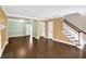 Open-concept living area with hardwood floors, staircase, and a view into the dining room at 84 Mount Vernon Cir, Atlanta, GA 30338