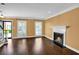 Cozy living room with hardwood floors, large windows, and a fireplace at 84 Mount Vernon Cir, Atlanta, GA 30338
