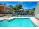 Community pool and tennis court with lounge chairs and umbrellas at 84 Mount Vernon Cir, Atlanta, GA 30338