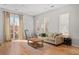 Bright living room with hardwood floors, a cozy sofa, and access to a private balcony at 1430 Dresden Ne Dr # 215, Atlanta, GA 30319