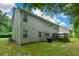 Home exterior featuring a cozy sunroom, grill, and green lawn at 325 Paces Dr, Lithia Springs, GA 30122