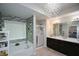 Bright bathroom featuring a separate shower, bathtub, and stylish chandelier lighting at 325 Paces Dr, Lithia Springs, GA 30122