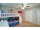Bright bedroom with a bunk bed, storage stairs, and wall art at 325 Paces Dr, Lithia Springs, GA 30122