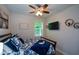 Cozy bedroom with a ceiling fan, decorative wall art, and ample natural light, ideal for relaxation at 325 Paces Dr, Lithia Springs, GA 30122