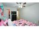 Playful bedroom features a dresser, ceiling fan, and convenient access to the walk-in closet at 325 Paces Dr, Lithia Springs, GA 30122