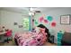 Bright bedroom featuring a Barbie-themed decor, ceiling fan, and ample natural light at 325 Paces Dr, Lithia Springs, GA 30122