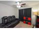 Relaxing room with a leather reclining couch, ceiling fan, and dark colored curtains at 325 Paces Dr, Lithia Springs, GA 30122