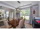 Traditional dining room features a chandelier, seating for six, and natural light from a nearby window at 325 Paces Dr, Lithia Springs, GA 30122