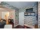 Inviting entryway boasts brick accent wall, hall tree, and dark hardwood floors at 325 Paces Dr, Lithia Springs, GA 30122